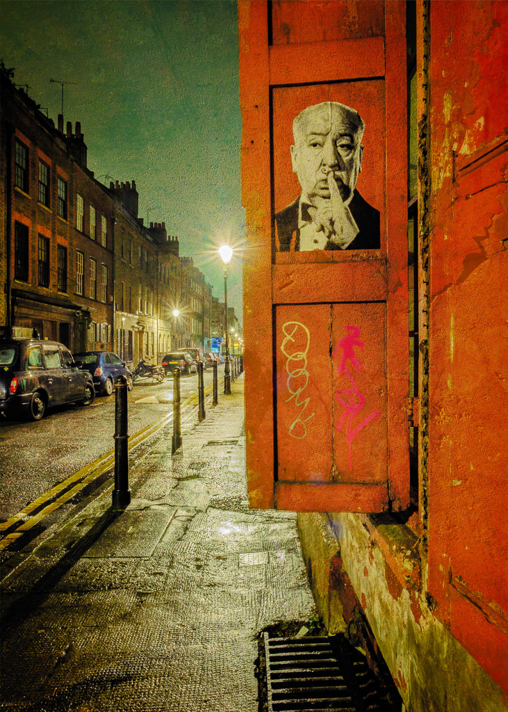 London street at night, red door with poster